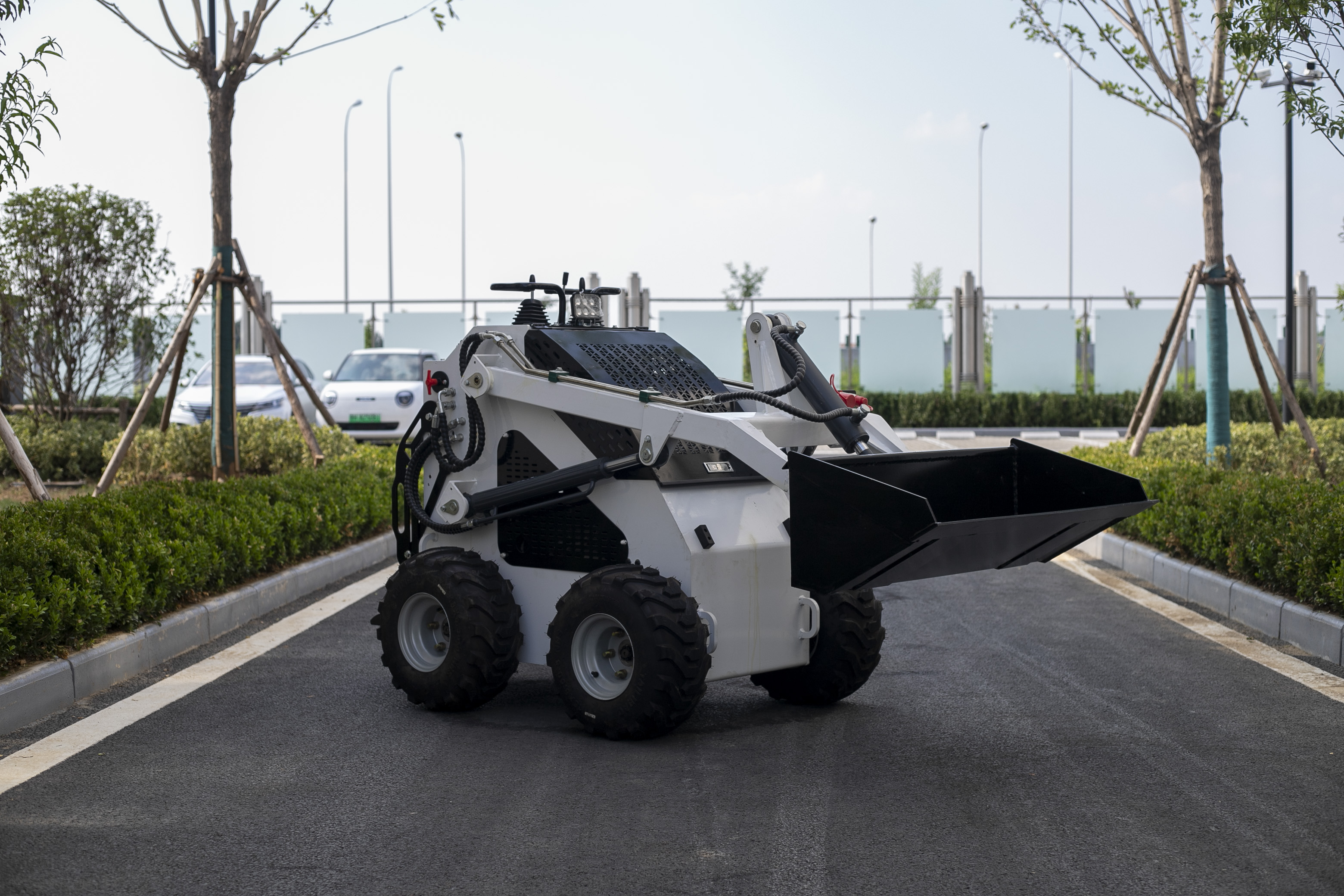 skid steer loader working with bucket attachment on construction and landscaping project