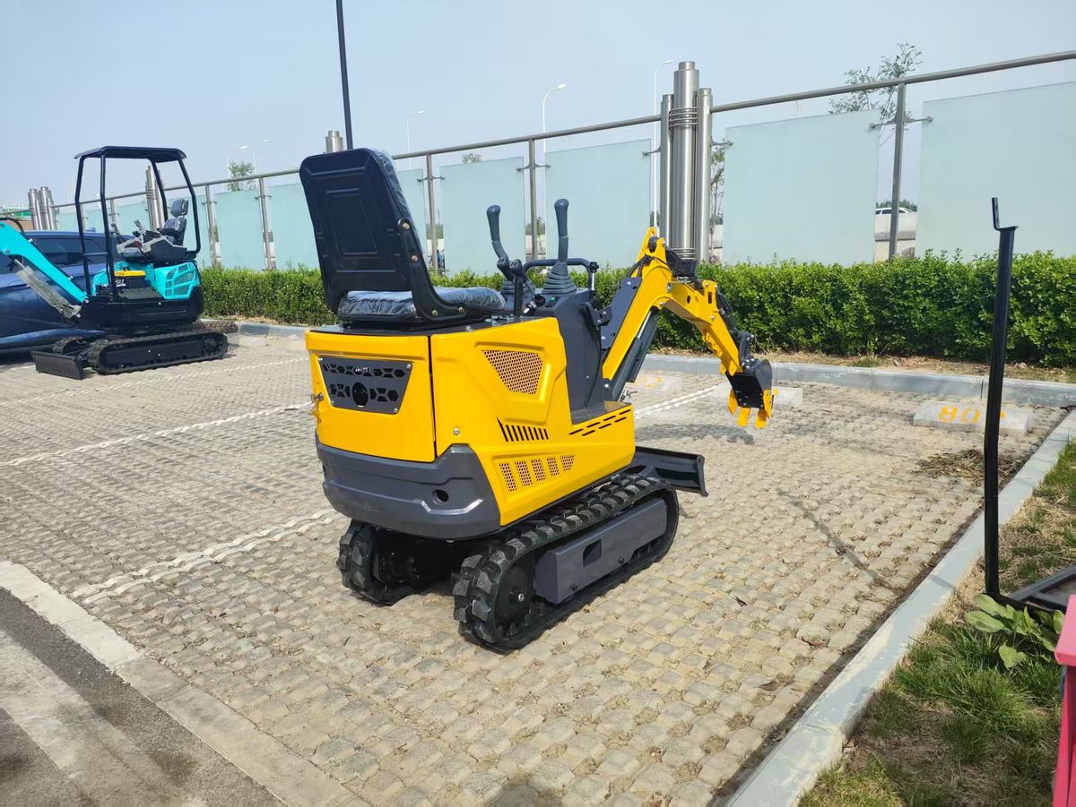 TOVISEN 06Q mini excavator with boom lowered over paved surface, product display