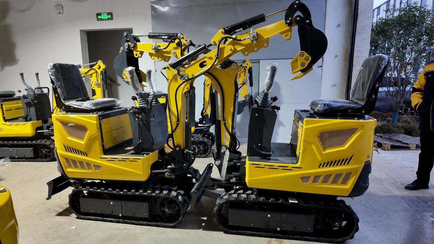 Mini excavators staged closely together with booms folded before container loading at the TOVISEN factory Mini excavators staged closely together with booms folded before container loading at the TOVISEN factory
