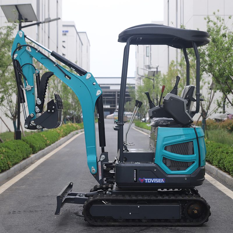 TOVISEN compact mini excavator with boom folded, product display in landscaped setting